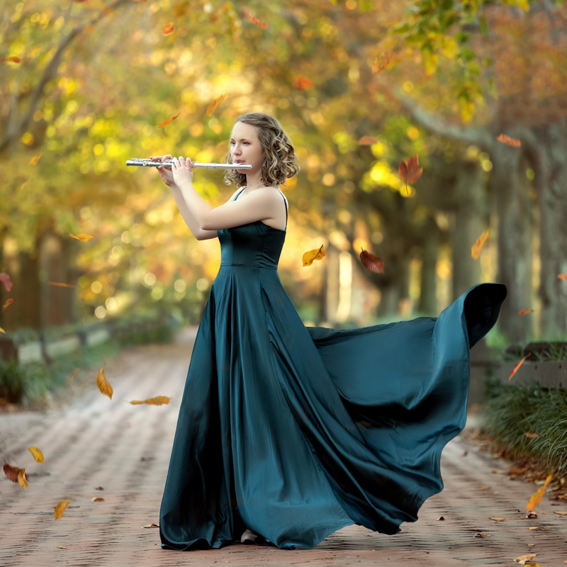 photo of a high school senior girl playing flue in the garden in the Fall taken by Marika H Photography