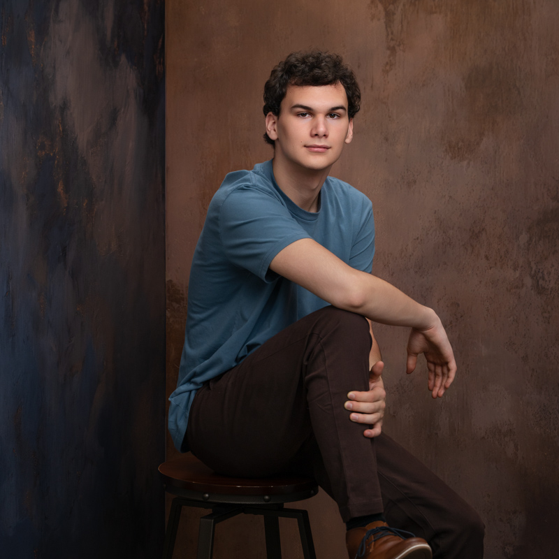 Portrait of a high school senior boy in blue and brown tones  captured in a studio in Williamsburg, VA, taken by Marika H Photography